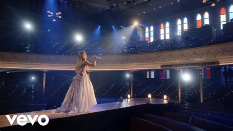 listen to carrie underwood how great thou art: How does Carrie Underwood's interpretation of How Great Thou Art reflect the themes of faith and redemption in her music?